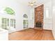 Open living room featuring a brick fireplace, built-in shelving, and French doors to the backyard at 3772 Christina Ct, Carmel, IN 46033