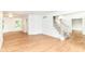 Open living room features wood floors and stairs to the second level, next to a dining area at 3772 Christina Ct, Carmel, IN 46033