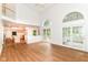 Spacious living area with high ceilings, wood floors, and an open layout to the kitchen and dining area at 3772 Christina Ct, Carmel, IN 46033