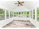 Bright sunroom with floor-to-ceiling windows, light-colored wood paneling, and stylish flooring at 3772 Christina Ct, Carmel, IN 46033