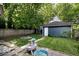 Fenced backyard with a fire pit and detached garage that enhance outdoor living and entertainment at 3934 N Kenwood Ave, Indianapolis, IN 46208