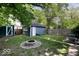 Fenced backyard featuring a shed, garage, fire pit, and grassy area, perfect for outdoor entertaining at 3934 N Kenwood Ave, Indianapolis, IN 46208