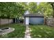 Private backyard with a fire pit, garage, and lush greenery creating an ideal space for relaxation and entertainment at 3934 N Kenwood Ave, Indianapolis, IN 46208