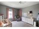 Comfortable bedroom with a ceiling fan, crib, dresser and good natural light creating a soothing atmosphere at 3934 N Kenwood Ave, Indianapolis, IN 46208