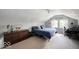 Bedroom with large window, ceiling fan, and sloped ceilings offering a cozy, intimate atmosphere at 3934 N Kenwood Ave, Indianapolis, IN 46208