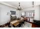This stylish dining room features hardwood floors, a decorative light fixture and seamlessly connects to other living spaces at 3934 N Kenwood Ave, Indianapolis, IN 46208