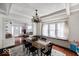 Bright dining room features a wooden table with seating for six, a large window seat, and hardwood floors at 3934 N Kenwood Ave, Indianapolis, IN 46208