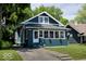 Charming two-story home featuring a blue exterior, bright windows, and a well-manicured lawn at 3934 N Kenwood Ave, Indianapolis, IN 46208