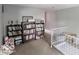 Hallway with a view of a staircase and multiple dark wood bookshelves filled with books and decor at 3934 N Kenwood Ave, Indianapolis, IN 46208