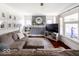 Cozy living room featuring neutral tones, a large window, and a decorative fireplace at 3934 N Kenwood Ave, Indianapolis, IN 46208