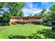 Expansive backyard with a well-maintained lawn and mature trees at 415 Woodhill Dr, Indianapolis, IN 46227