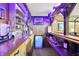 Finished basement bar with wooden countertop and shelves, plus a mini fridge for entertaining guests at 415 Woodhill Dr, Indianapolis, IN 46227