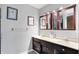 Well-lit bathroom features double sinks, attractive fixtures, and a large framed mirror above vanity at 415 Woodhill Dr, Indianapolis, IN 46227