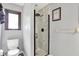 Bathroom showcasing a new walk-in shower with white marble-patterned walls and matte black fixtures at 415 Woodhill Dr, Indianapolis, IN 46227