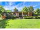 Charming brick ranch-style home with well-manicured lawn and inviting front porch at 415 Woodhill Dr, Indianapolis, IN 46227