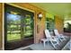 Inviting covered front porch with classic brick accents and comfortable seating at 415 Woodhill Dr, Indianapolis, IN 46227