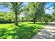 Large front yard with mature trees at 415 Woodhill Dr, Indianapolis, IN 46227