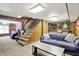 Spacious carpeted living room with staircase, a cozy bar, and comfortable seating for relaxing at 415 Woodhill Dr, Indianapolis, IN 46227