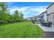 Well-maintained backyard with a lush lawn, patio area, firepit, and a view of neighboring homes at 4602 Hayward Way, Westfield, IN 46062