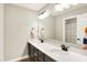 Bathroom with double sinks and a large mirror, offering a view of the shower area with a colorful curtain at 4602 Hayward Way, Westfield, IN 46062