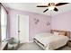 Bedroom features a cozy bed, a plush armchair, a ceiling fan, and window that provides natural light at 4602 Hayward Way, Westfield, IN 46062