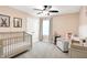 Bedroom showcasing a crib, a cozy armchair, bunny artwork, and a window with soft natural light at 4602 Hayward Way, Westfield, IN 46062