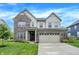 Charming two-story home featuring brick and siding, a two-car garage, and a well-manicured front yard at 4602 Hayward Way, Westfield, IN 46062