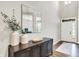 Bright foyer with high ceilings, decorative mirror and table, and a white front door at 4602 Hayward Way, Westfield, IN 46062