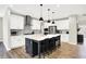 Bright kitchen with white cabinets, a large island with seating, and modern appliances at 4602 Hayward Way, Westfield, IN 46062