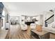 Open-concept living room with hardwood floors, modern decor, and an open view of the kitchen at 4602 Hayward Way, Westfield, IN 46062
