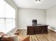 Inviting office featuring a large desk, leather chair, and a cozy armchair by the window at 4602 Hayward Way, Westfield, IN 46062