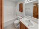 Clean bathroom featuring a shower-tub combo, modern sink, and wood cabinetry at 4825 May Ridge Ln, Indianapolis, IN 46254