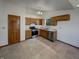 Kitchen with tile flooring, stainless steel appliances, wood cabinets, and a window at 4825 May Ridge Ln, Indianapolis, IN 46254