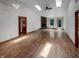 Spacious living room featuring vaulted ceilings, skylights, and hardwood floors at 4825 May Ridge Ln, Indianapolis, IN 46254