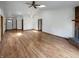 Open living space with hardwood floors, a brick fireplace, and natural light at 4825 May Ridge Ln, Indianapolis, IN 46254