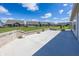 Expansive concrete patio surrounded by a brick retaining wall, showcasing a view of the neighborhood and lush green lawns at 5196 Canberra Ct, McCordsville, IN 46055