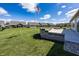 Backyard features a concrete patio with brick retaining wall, well-manicured lawn, and view of the neighborhood at 5196 Canberra Ct, McCordsville, IN 46055