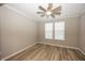 Neutral bedroom with wood-look flooring and a modern ceiling fan fixture at 5196 Canberra Ct, McCordsville, IN 46055