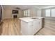Bright kitchen and dining combo featuring a kitchen island, stainless steel appliances and hardwood floors at 5196 Canberra Ct, McCordsville, IN 46055