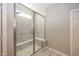Shower stall featuring glass doors, built-in seating, and tiled walls at 5196 Canberra Ct, McCordsville, IN 46055