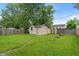 Grassy backyard featuring storage shed at 5473 E 18Th St, Indianapolis, IN 46218
