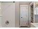 Bathroom featuring white tiled shower and storage shelves at 5473 E 18Th St, Indianapolis, IN 46218