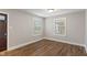Bright bedroom with hardwood floors and natural light from two windows at 5473 E 18Th St, Indianapolis, IN 46218