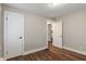 Bedroom featuring hardwood floors, closet, and neutral wall paint at 5473 E 18Th St, Indianapolis, IN 46218