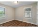 Bright bedroom featuring two windows and wood-look floors at 5473 E 18Th St, Indianapolis, IN 46218