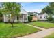 Cozy home with verdant lawn, mature tree, and convenient carport at 5473 E 18Th St, Indianapolis, IN 46218