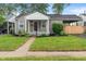 Charming single-story home boasts well-manicured lawn and inviting front porch at 5473 E 18Th St, Indianapolis, IN 46218