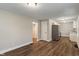 Open-concept living space with hardwood flooring leading into kitchen at 5473 E 18Th St, Indianapolis, IN 46218