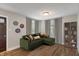 Inviting living room with an olive green couch, warm wood floors, and bright natural light at 5473 E 18Th St, Indianapolis, IN 46218