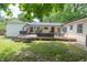 The backyard features a spacious deck with outdoor seating, a grill, and green grass perfect for outdoor entertaining at 5601 Rosslyn Ave, Indianapolis, IN 46220